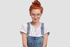 Free photo candid shot of pleasant looking female with ginger hair bun