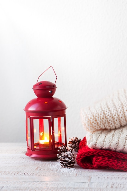 Free photo candle in a lamp with towels next to it