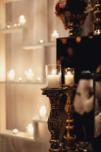 Candle shines in a bronze candleholder