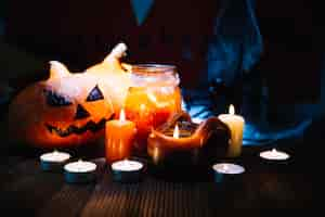 Free photo candles and pumpkins in spooky arrangement