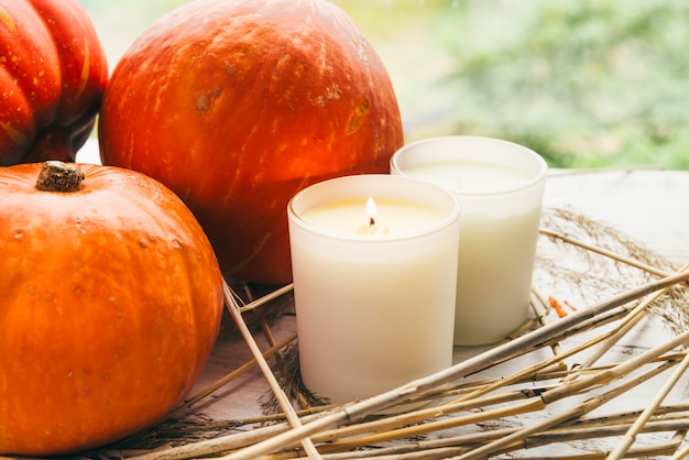 Free photo candles and pumpkins on table