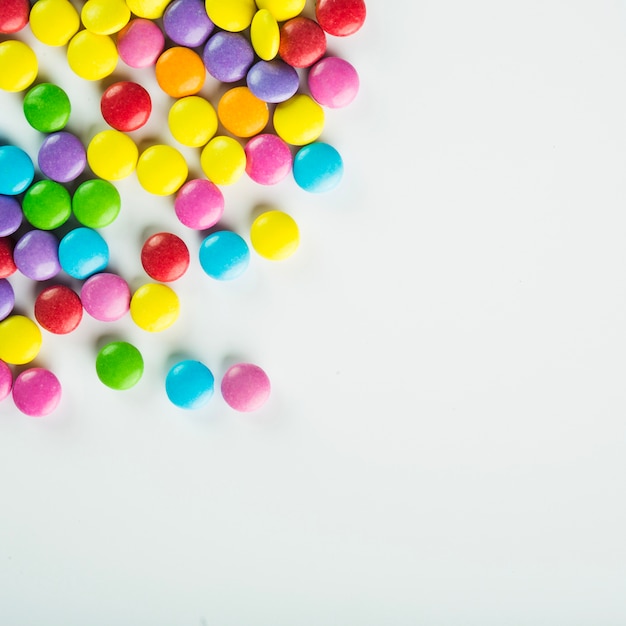 Candy buttons in corner of white background