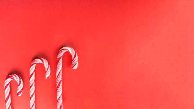 Candy canes composition on red