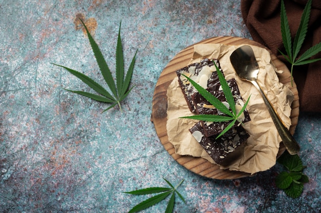 Free Photo cannabis brownies and cannabis leaves put on wooden cutting board