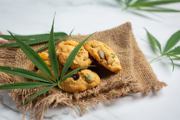 Cannabis cookies and cannabis leaves put on fabric