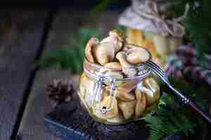 Free photo canned edible porcini mushrooms in a glass jar homemade pickled mushrooms