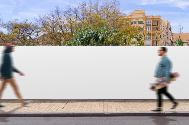 Canvas fence in a street with people walking