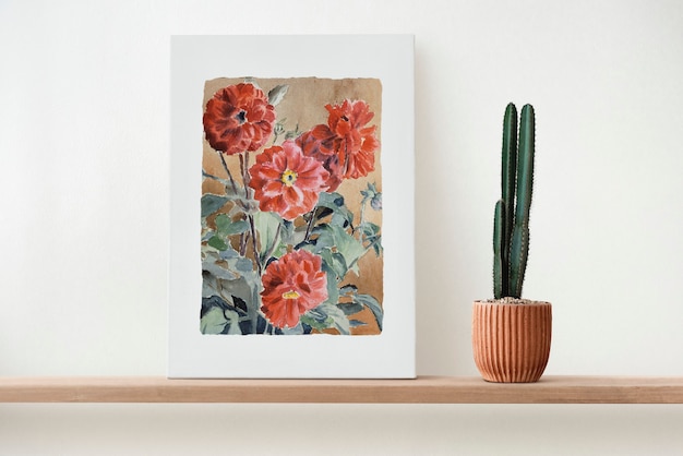 Free photo canvas wall art on a wooden shelf with cactus