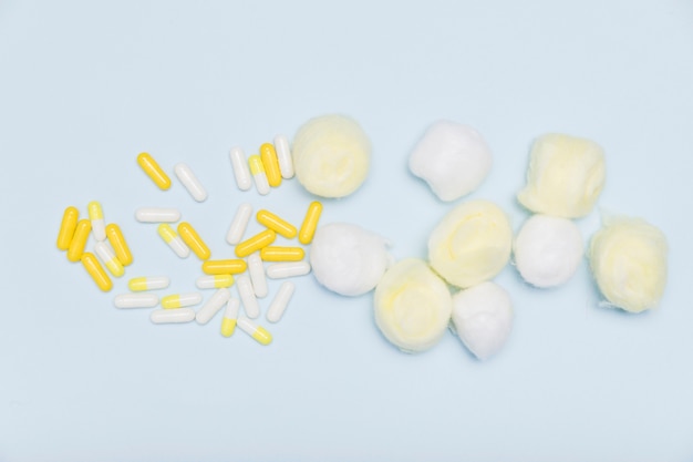 Capsules and cotton balls flat lay