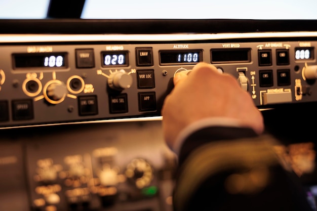 Free photo captain pushing buttons to fix altitude level on control panel command, using navigation switch to fly airplane jet. power radar with dashboard and handle to takeoff with plane. close up.