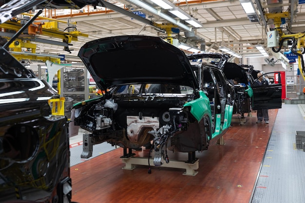 Free photo car bodies are on assembly line factory for production of cars modern automotive industry a car being checked before being painted in a hightech enterprise