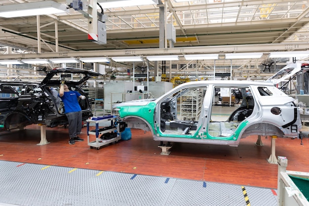 Free photo car bodies are on assembly line factory for production of cars modern automotive industry a car being checked before being painted in a hightech enterprise