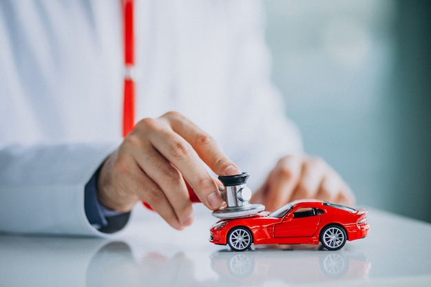 Car doctor with stethoscope in a car showroom