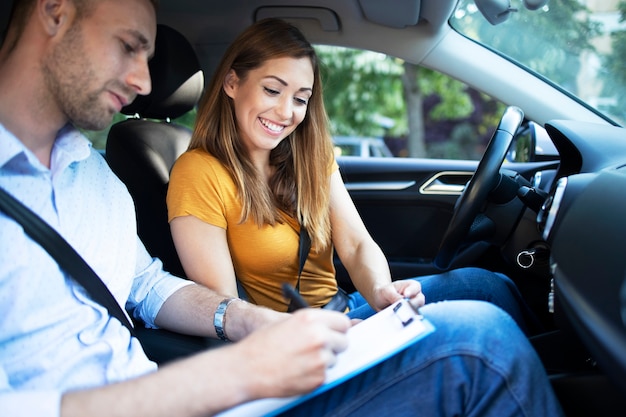 Car instructor explaining city traffic rules before driving a car