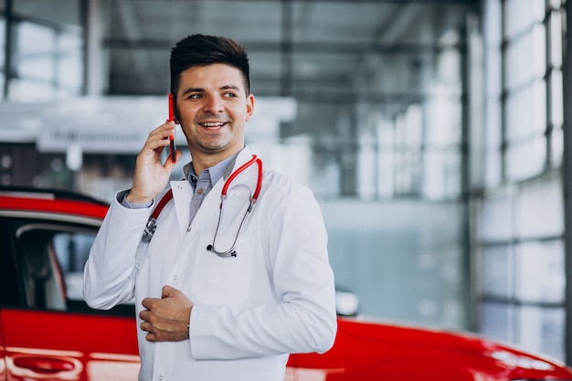 car technician with stethoscope in a car showroom talking on the phone