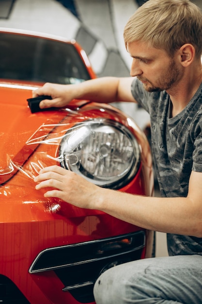 Free Photo car wrapping with foil at car service