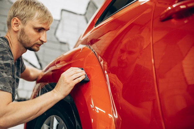 Free Photo car wrapping with foil at car service