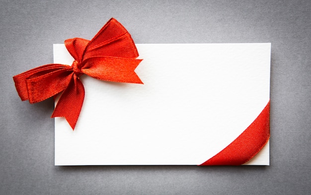 Card with red ribbons bows