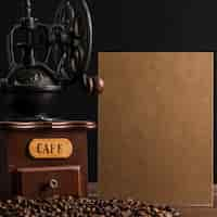 Free photo cardboard and vintage coffee grinder near beans