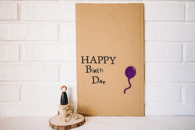 Cardboard with birthday writing and toy figure