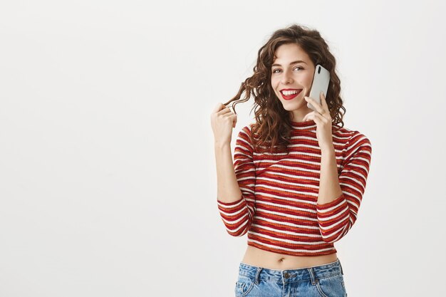 Carefree beautiful girl talking on smartphone