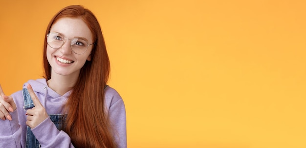 Free photo carefree charismatic happy silly young cute redhead girl freckles blue eyes wearing glasses enjoy