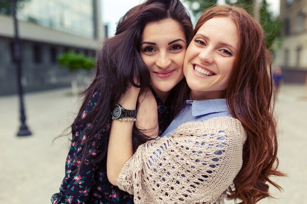 Carefree smiling sisters hugging and having fun together