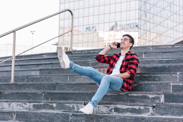 Carefree young man talking on smartphone