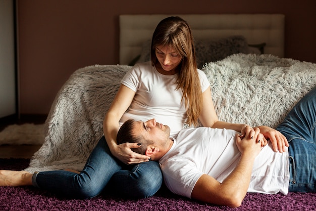 Careful woman watching her boyfriend sleeping