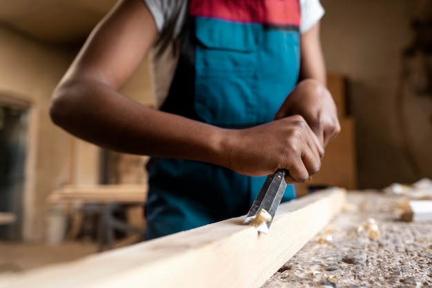 Carpenter cutting mdf board inside workshop