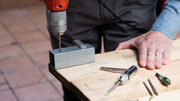 Free photo carpenter in the process of making a wooden table