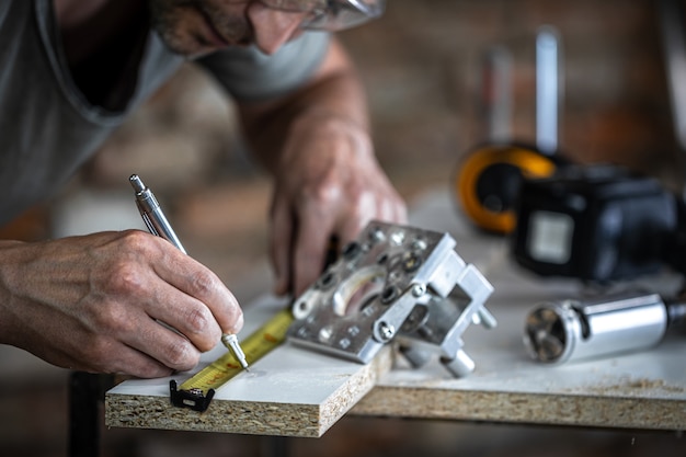 Free Photo a carpenter in the process, a professional tool for precision drilling in wood.