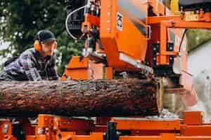 Free photo carpenter working on a sawmill on a wood manufacture