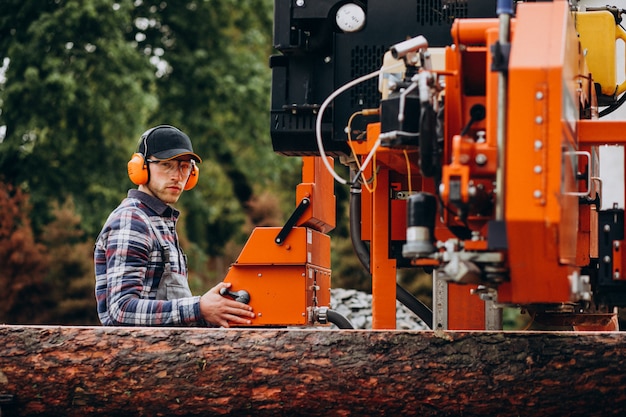 Free photo carpenter working on a sawmill on a wood manufacture