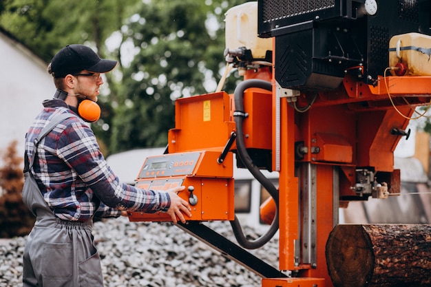 Free Photo carpenter working on a sawmill on a wood manufacture