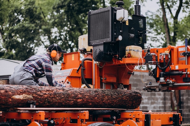 Free photo carpenter working on a sawmill on a wood manufacture