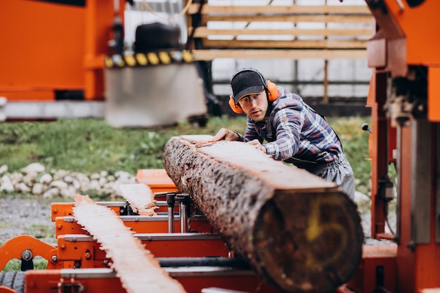 Free Photo carpenter working on a sawmill on a wood manufacture