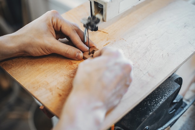 The carpenter works with a tree