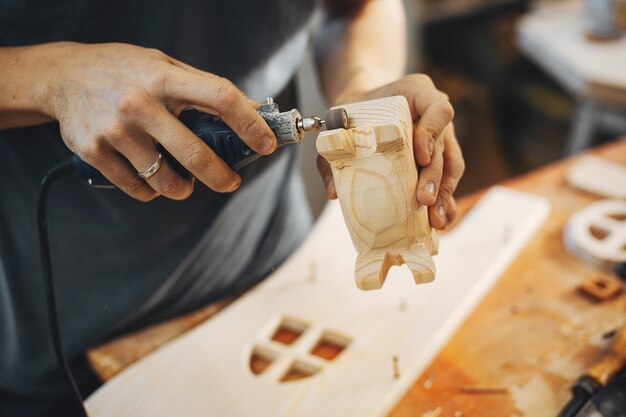 The carpenter works with a tree