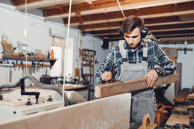 The carpenter works with a tree