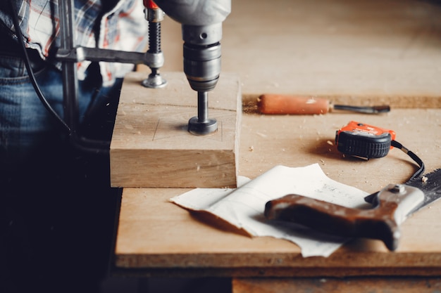 The carpenter works with a tree