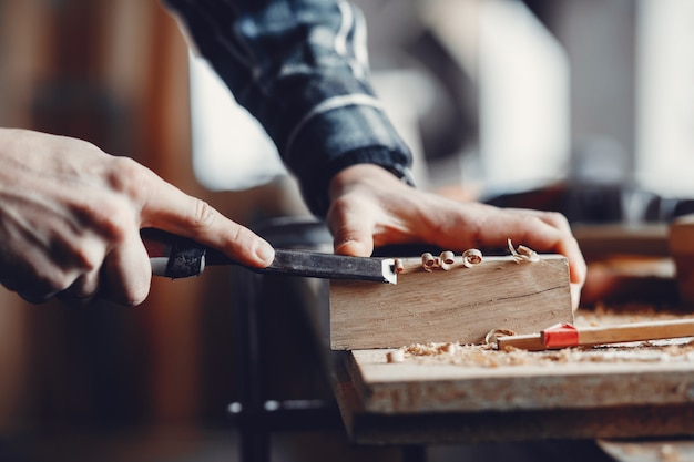 The carpenter works with a tree