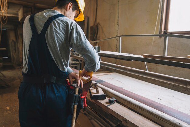 Carpentry concept with man working on wood