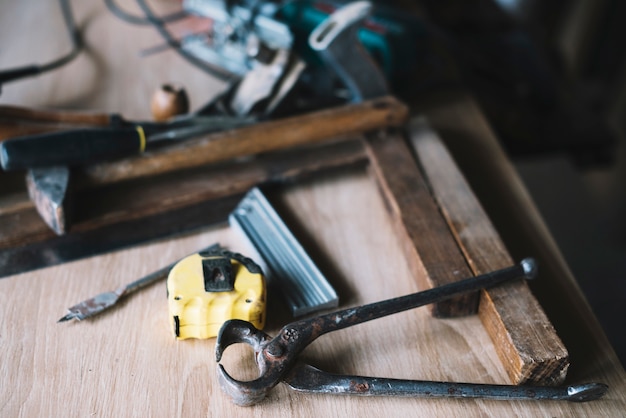 Free photo carpentry concept with pliers and tape measure