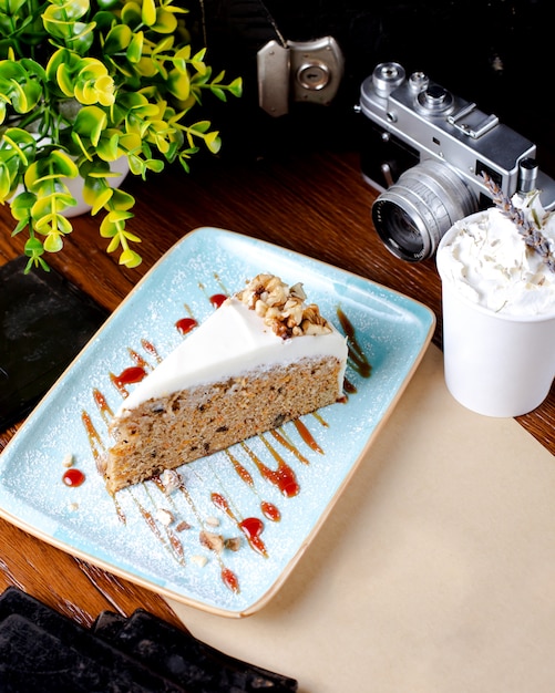 Free photo carrot cake topped with whipped cream and nuts