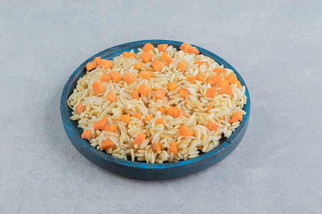 Carrot rice in the wooden plate , on the marble.