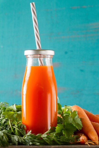 Carrot smoothie with drinking straw