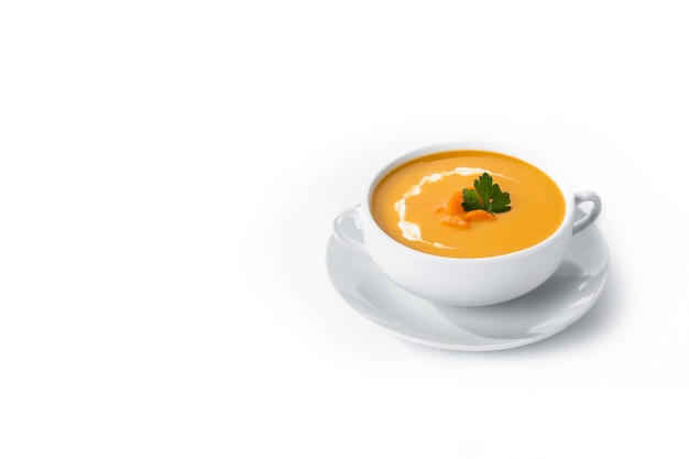 Carrot soup with cream and parsley isolated on white background