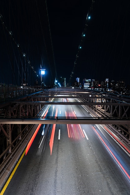 Free photo cars on bridge with motion blur at night