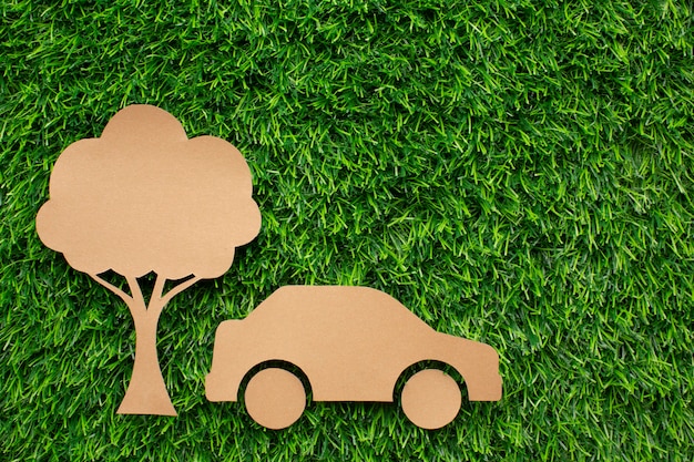 Free photo cartoon car and tree in grass